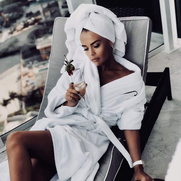 Красивая девушка в полотенце на улице на фото